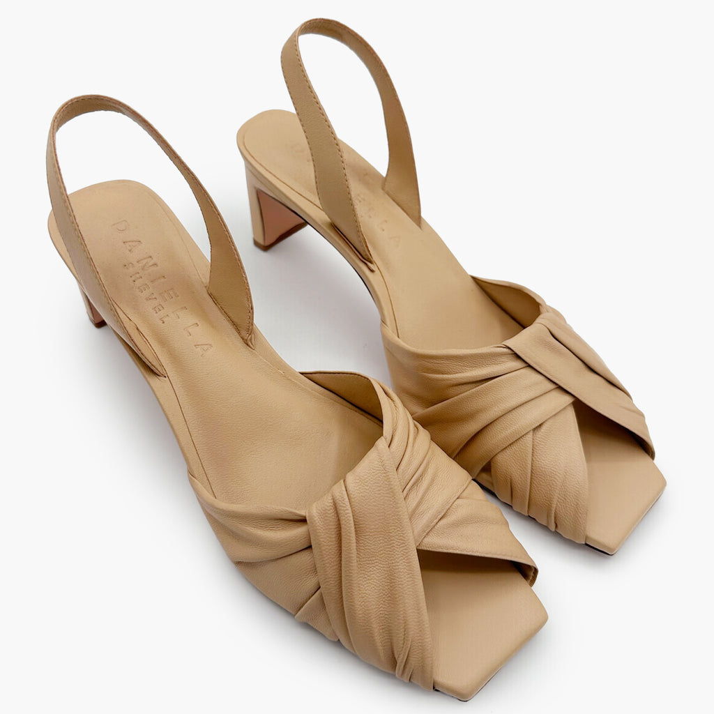 Flat-lay side capture of Riley soft oat sandals highlighting texture and shape.