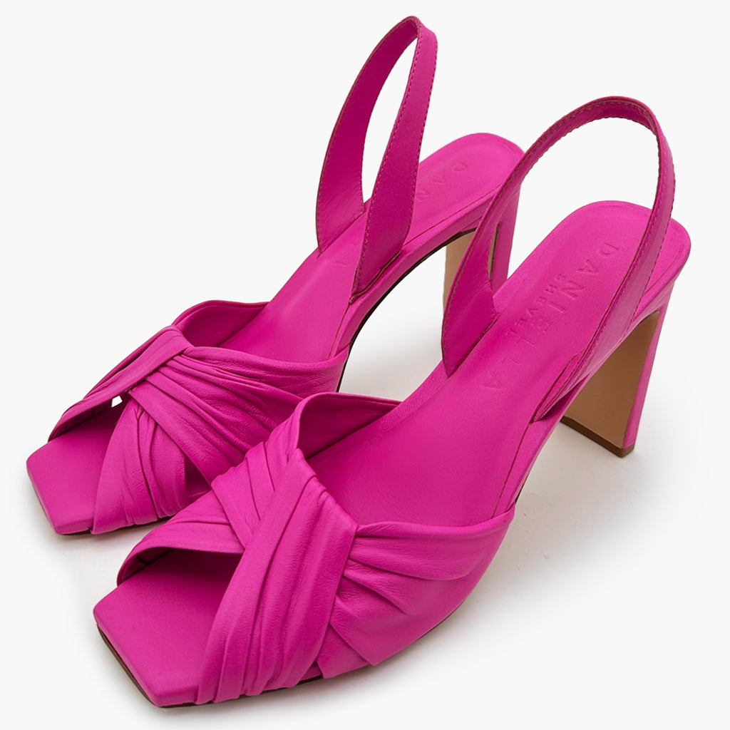 Close-up studio shot of a pair of intense pink Skyler slingback leather detail.