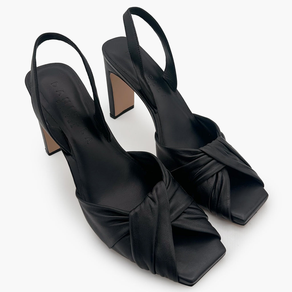 Close-up of Skyler slingback in black leather with twisted strap design.