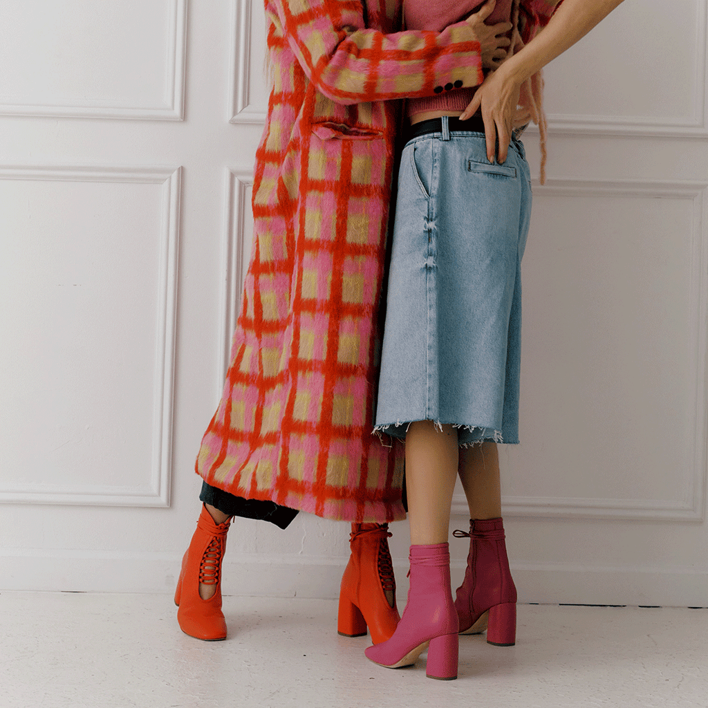 Daniella Shevel Belladonna Lace up boot in lobster red and Belladonna in intense pink with jeans and winter coat
