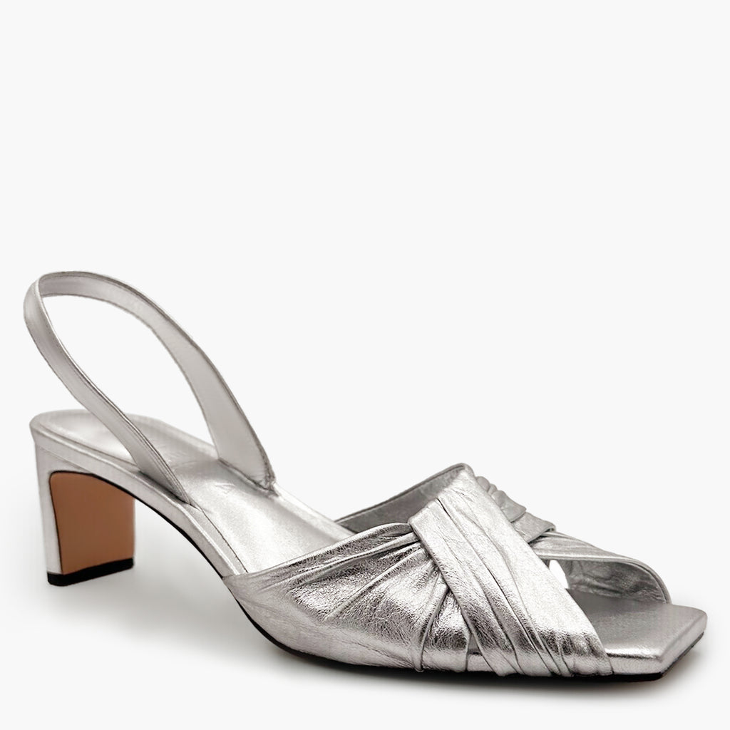Flat-lay studio capture of Riley Leather Low-Heel in metallic silver.