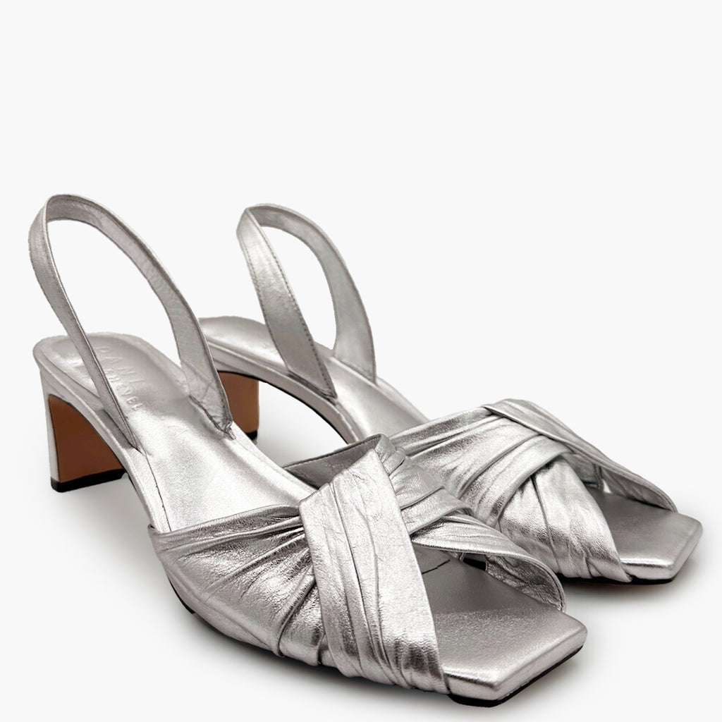 Side view pair shot of Riley silver sandals highlighting sculptural leather straps.