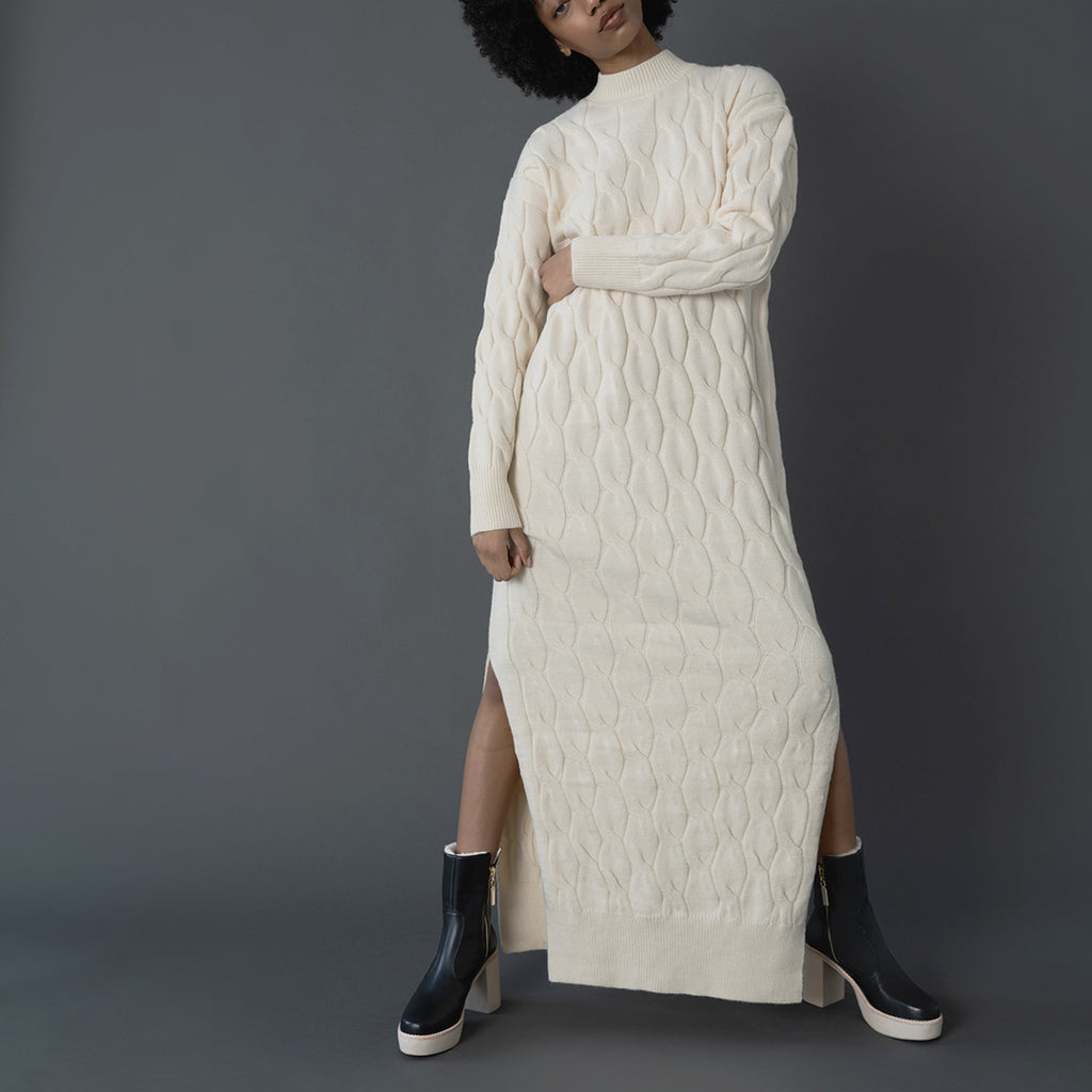Daniella Shevel Aspen Shearling Boot in black waterproof and weatherproof with rubber lugg sole with white knit dress